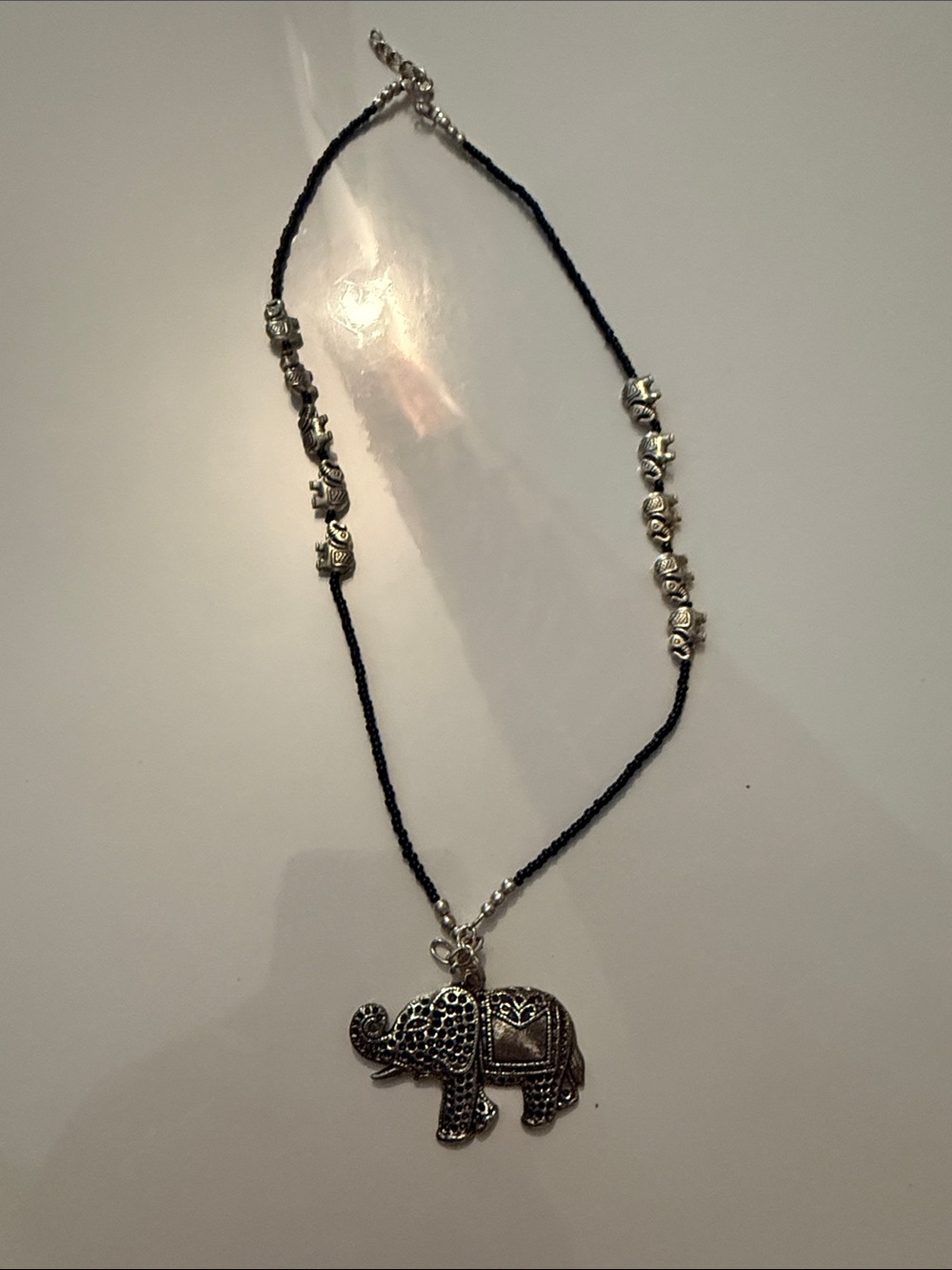 boho elephant pendant necklace with Black seed beads & mini elephant silver tone